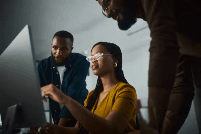 Colleagues reviewing work together at a computer
