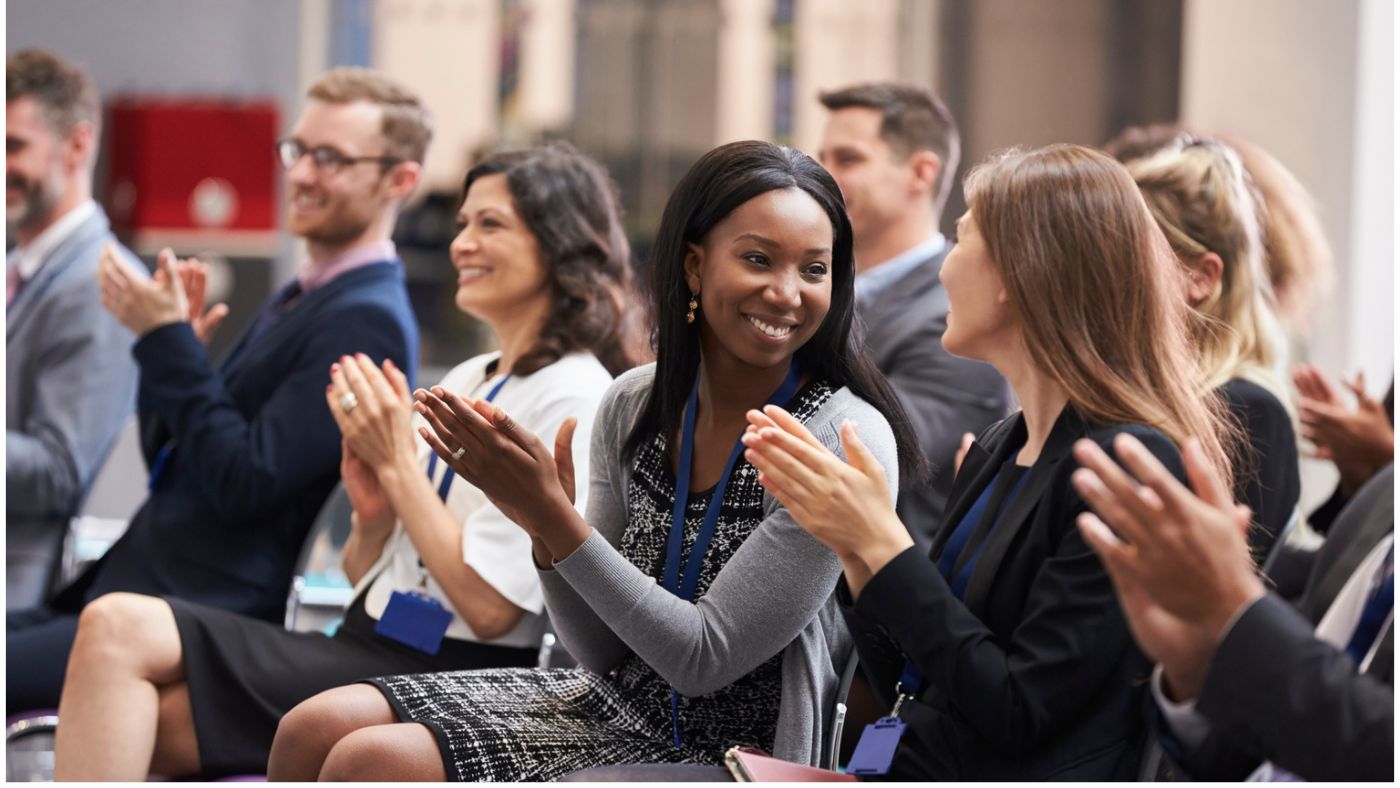 Delegates applauding at an AI conference